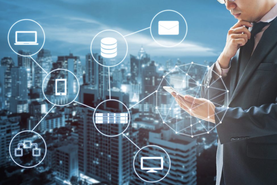 Double exposure of businessman connected internet and wireless network with his smart phone and city of business background in business trading and technology concept